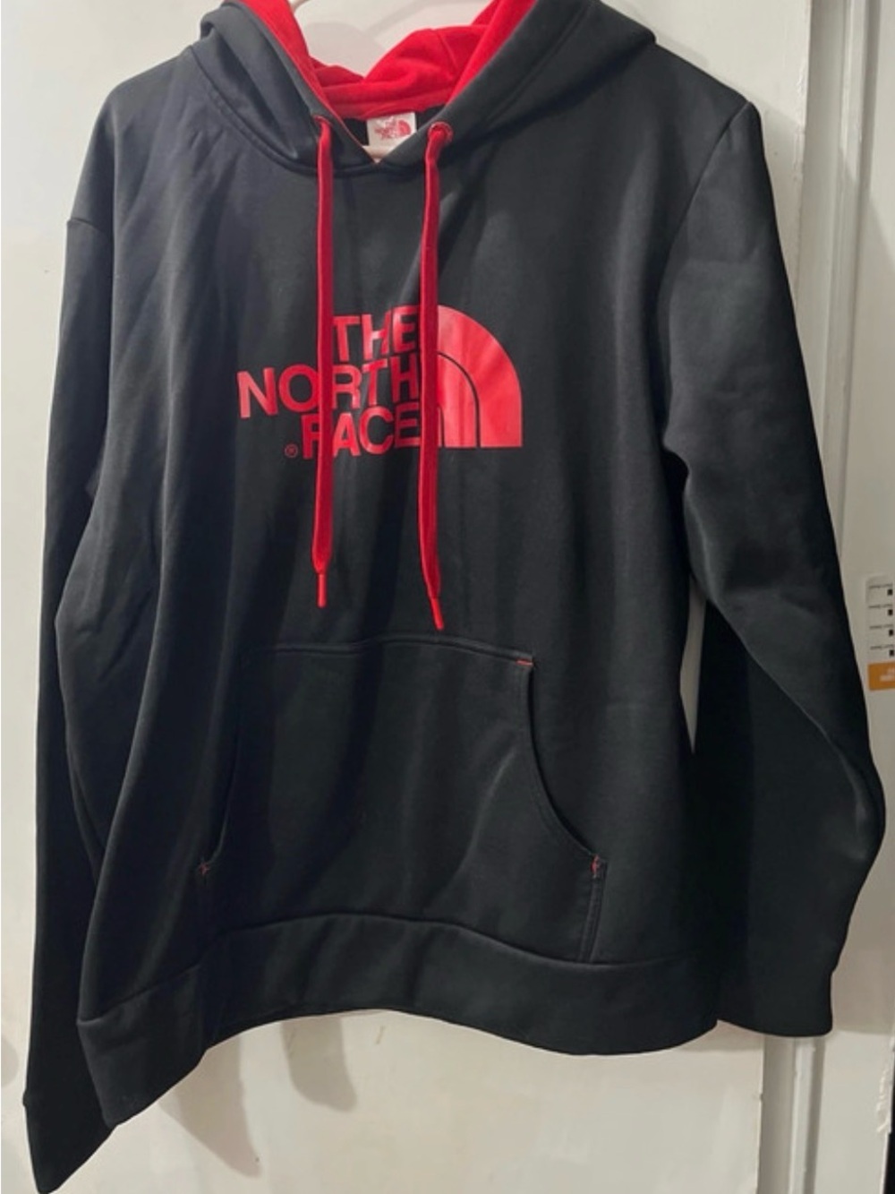 The North Face Black Hoodie with Red Logo and Lined Hood